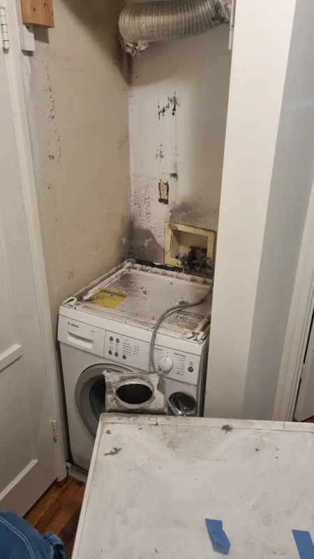 Washer and dryer repair service in a laundry closet