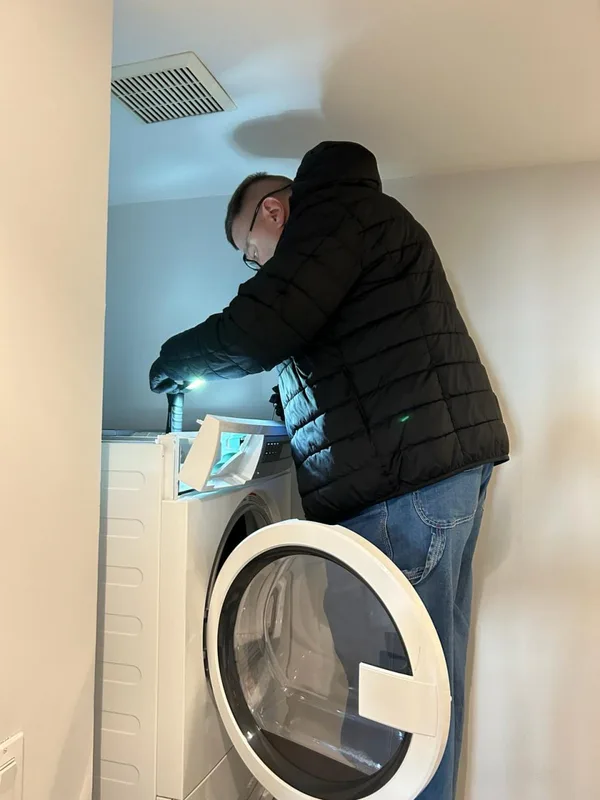 Technician servicing microwave internal components